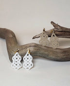 Close-up of white and beige gourd-shaped Mizuhiki awaji knot earrings handmade by Itookasi. A blend of Japanese craft and Finnish nature symbolizing strong bonds.