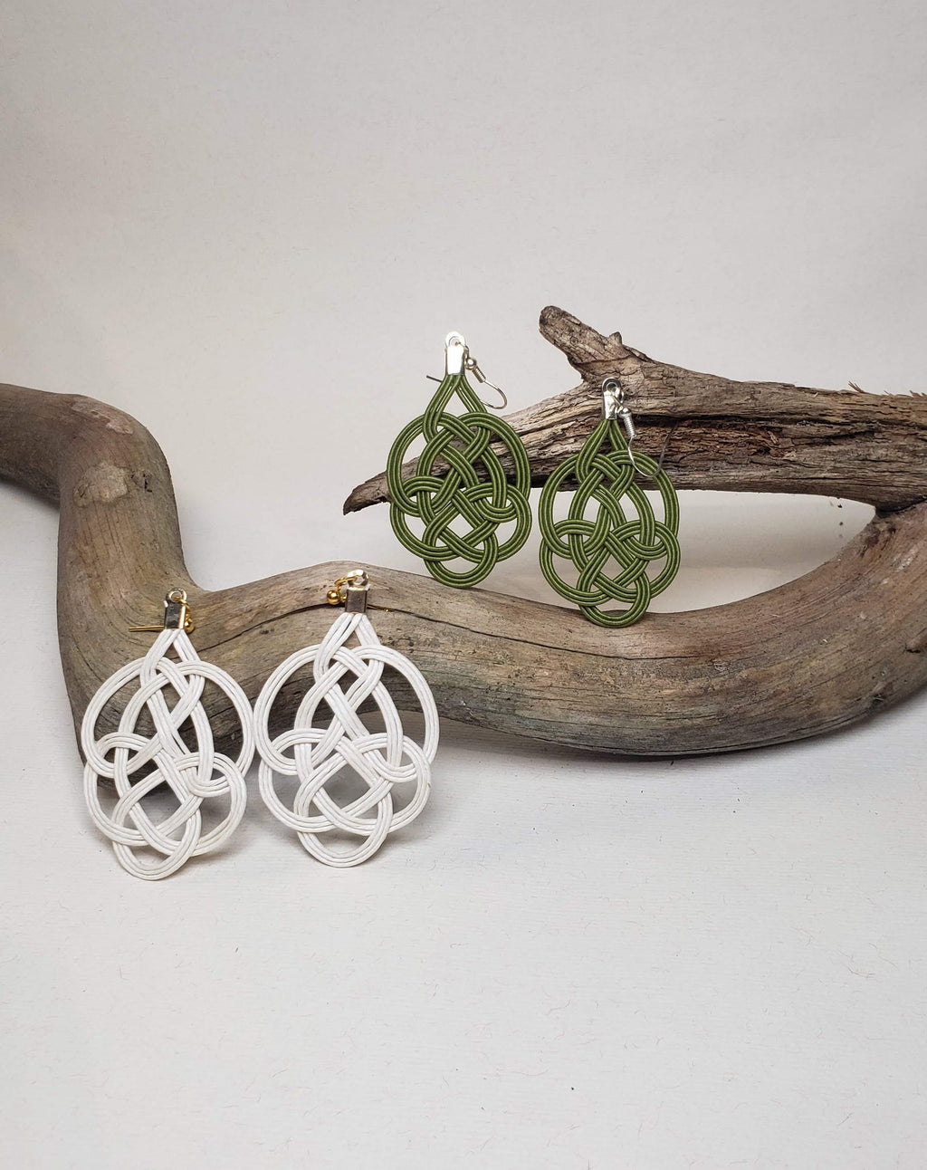 Close-up of black Mizuhiki Awaji knot earrings featuring a delicate goldfish charm, worn by a model, handmade by itookasi. 