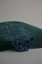 Close-up of a black Mizuhiki pine knot necklace, handmade by Itookasi. The pine knot (Matsu-musubi) symbolises longevity and happiness.