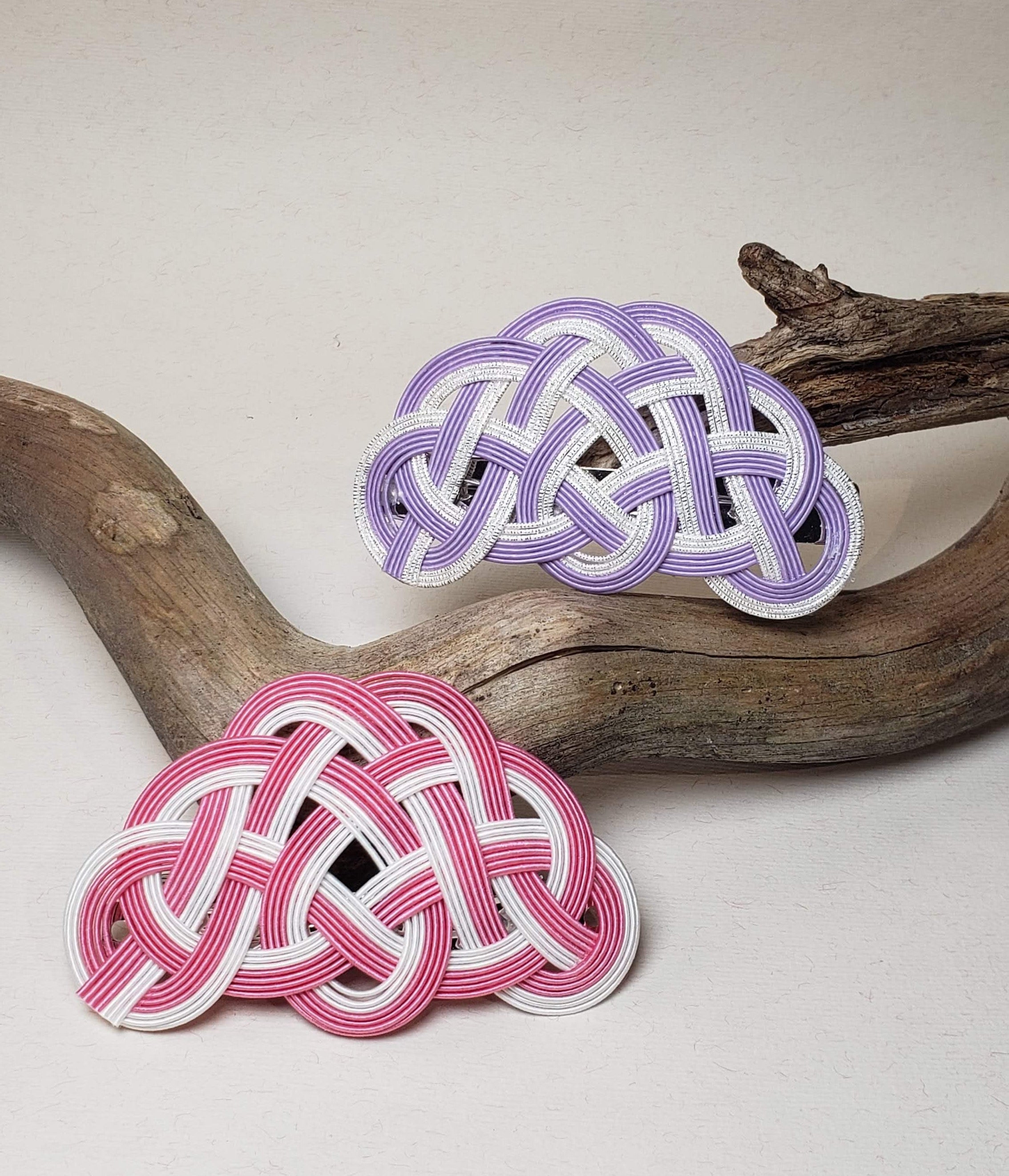 Close-up of a pink and purple Mizuhiki pine knot hair barrettes, handmade by Itookasi. 