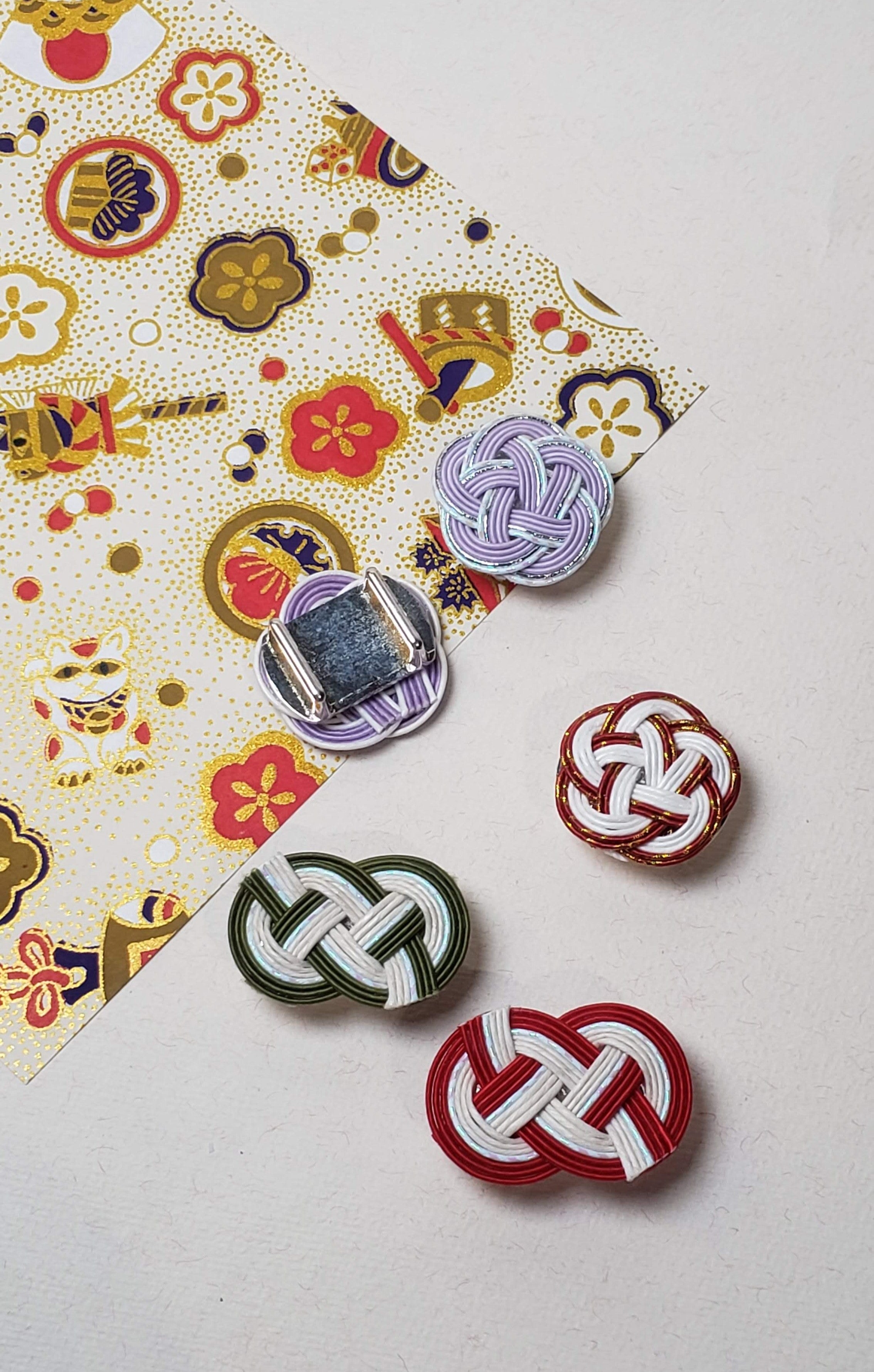 Close-up of Mizuhiki plum Knot and idaki-awaji knot obidome for kimono, handmade by itookasi for eternal bonds.