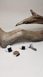 Close-up of the metal parts of the Awaji knot earrings with an onigiri (rice ball) design.