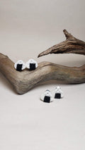 Close-up of earrings with an onigiri (rice ball) design and Awaji knot. Handmade by Itookasi.