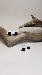 Close-up of earrings with an onigiri (rice ball) design and Awaji knot. Handmade by Itookasi.