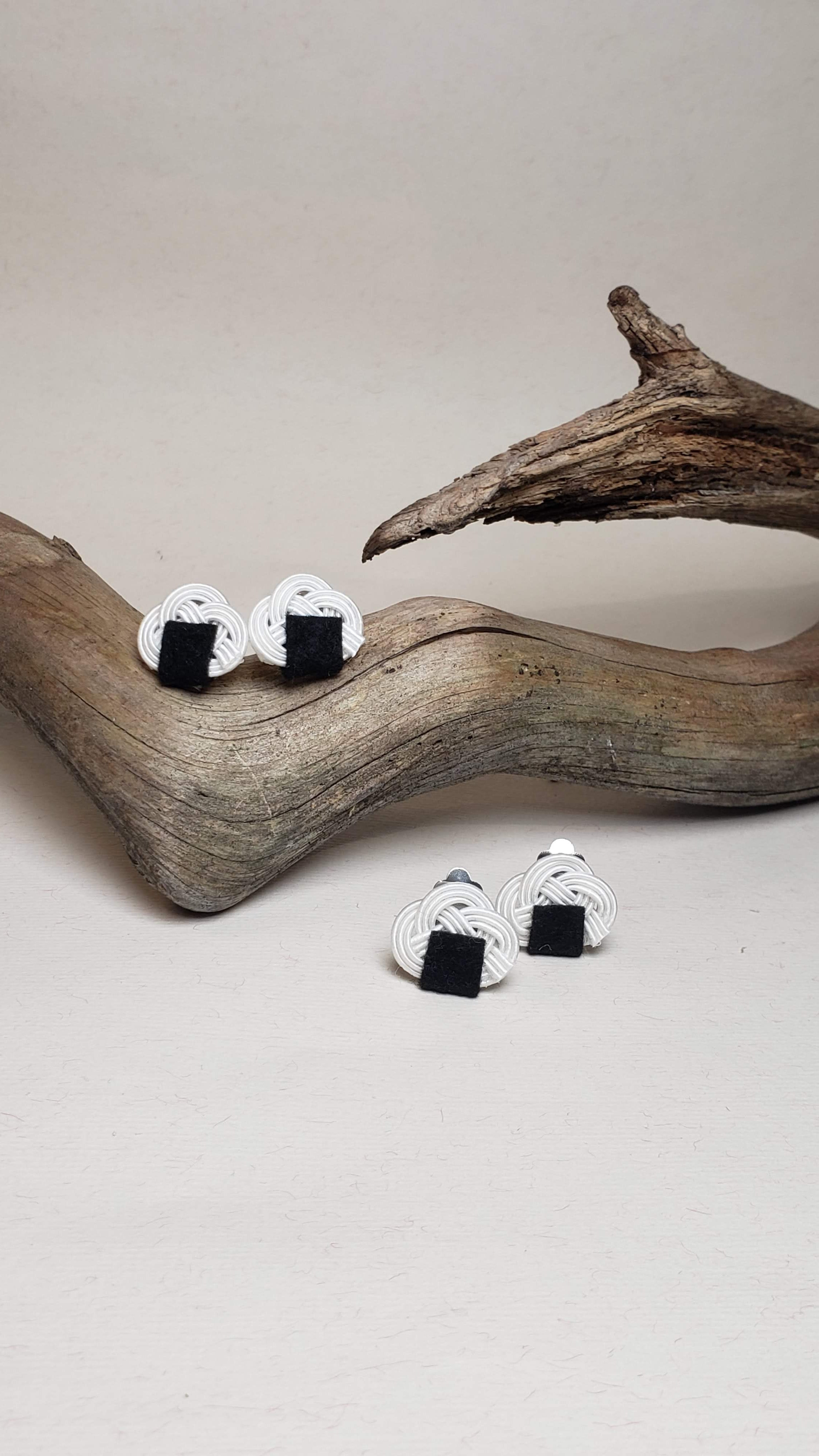 Close-up of earrings with an onigiri (rice ball) design and Awaji knot. Handmade by Itookasi.